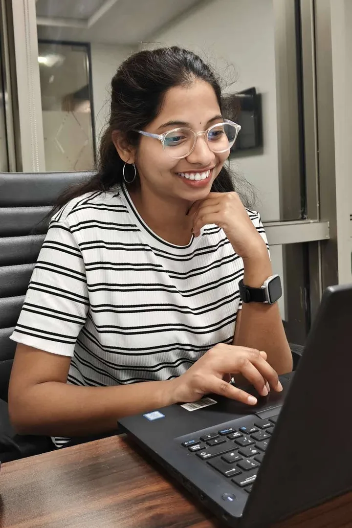Srinavya Kakkirala smiling at her laptop